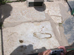 outline of foot carved in marble